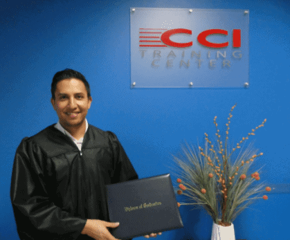 graduate of CCI Training Center information technology program holding diploma