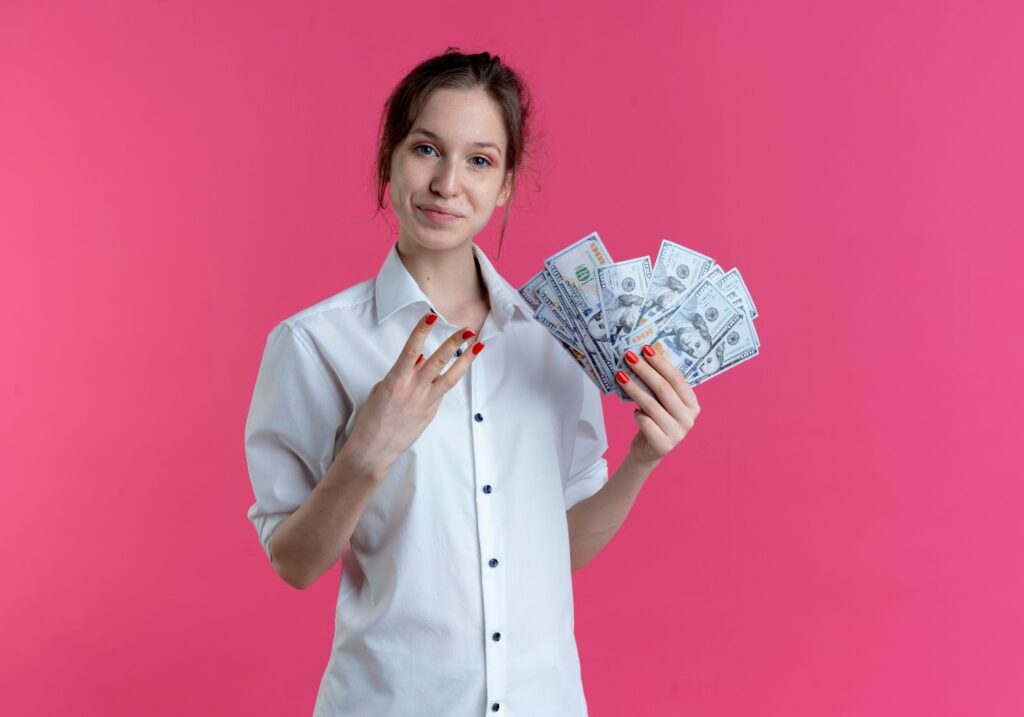 Certified Nursing Assistant holding cash in her left hand, symbolizing CNA salary and earning potential in the United States